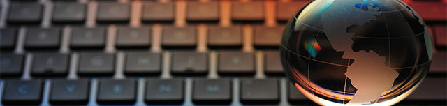 Glass globe on computer keyboard