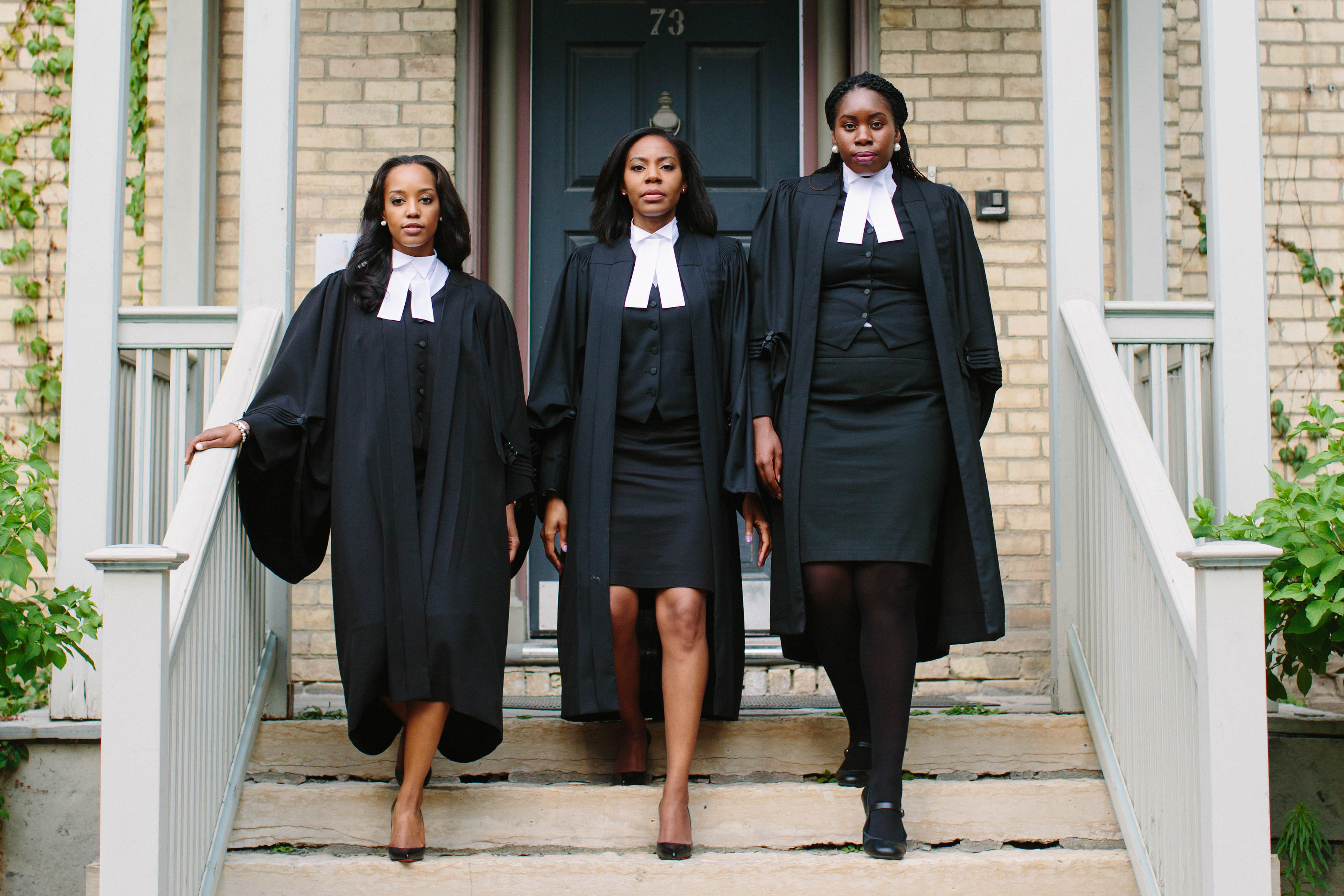 3 female jd grads in lawyers robes