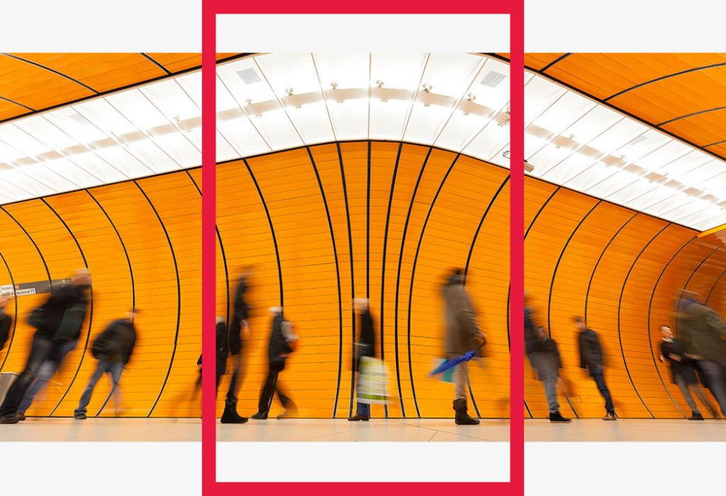 A group of commuters in a subway station.