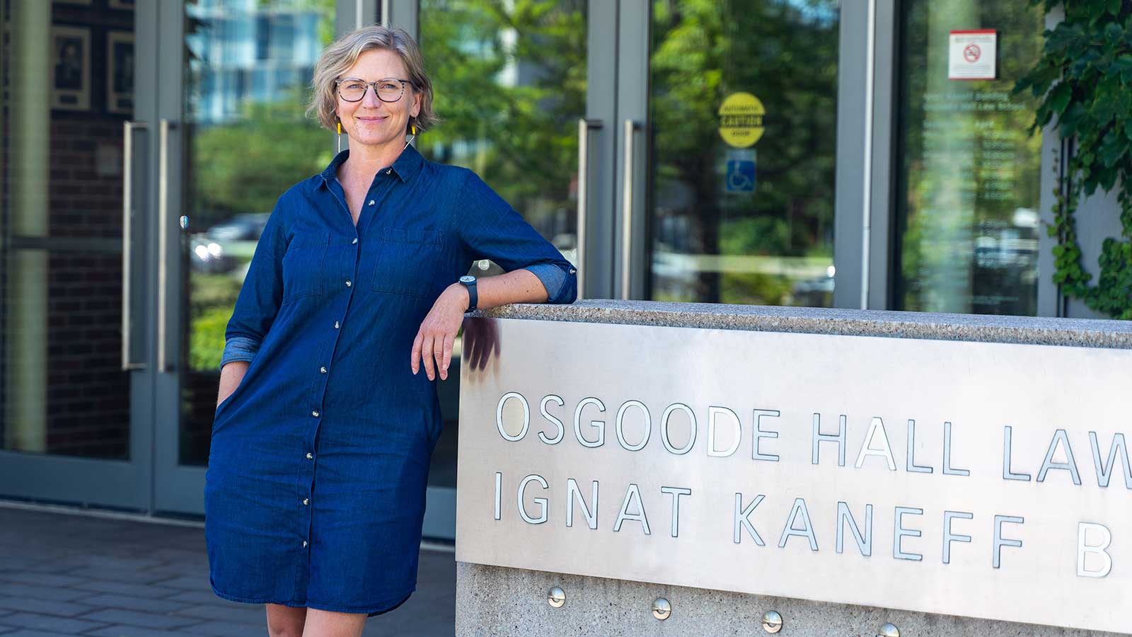 Dayna scott standing at entrance to osgoode hall law school