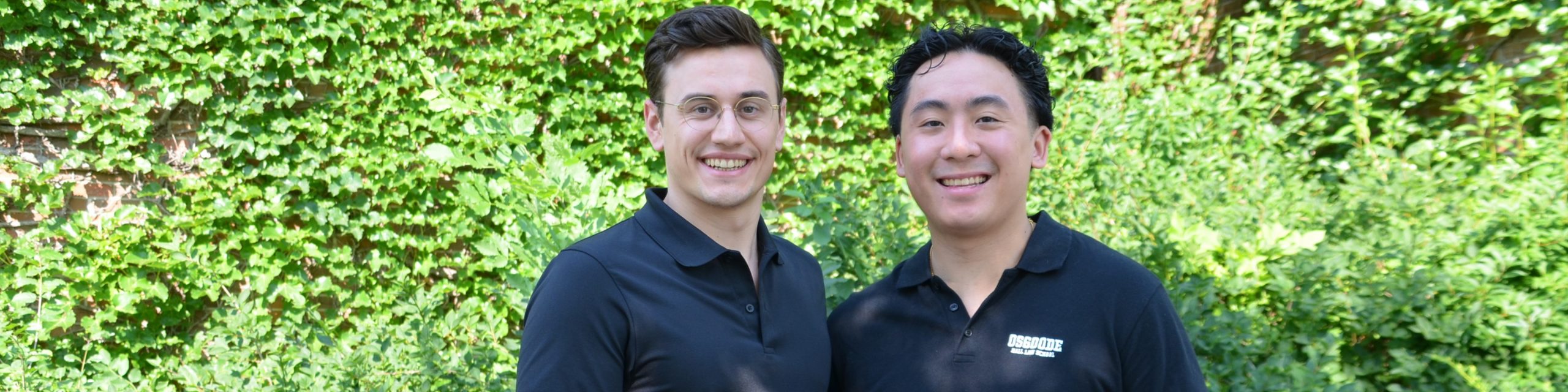 Photo of CLASP law students Louis Althaus (left) and Brandon Jeffrey Jang again green ivy of Osgoode main entrance.