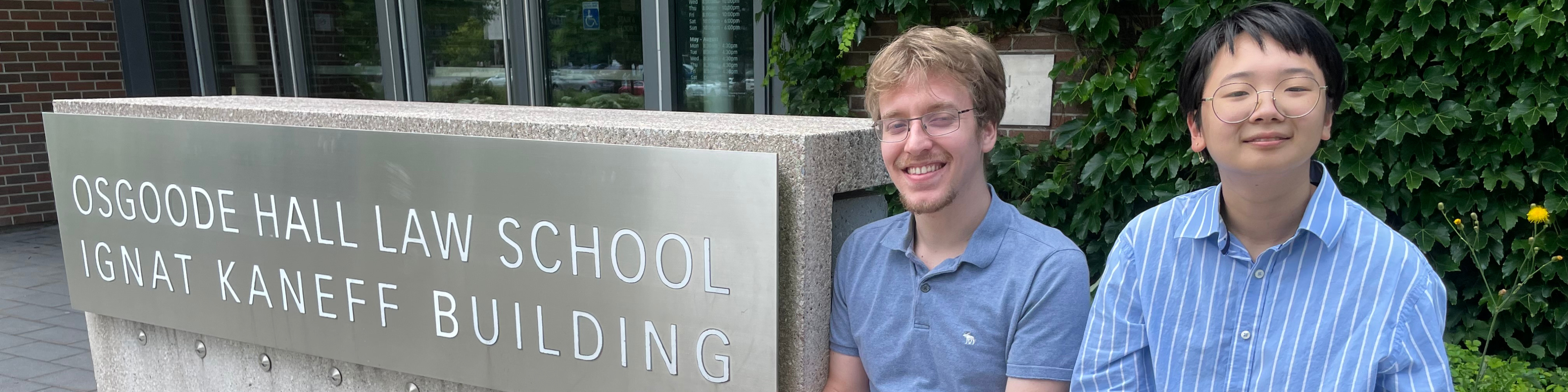 Photo of Osgoode Hall Law School students Ryan Boros (left) and Elias Tung beside Osgoode sign