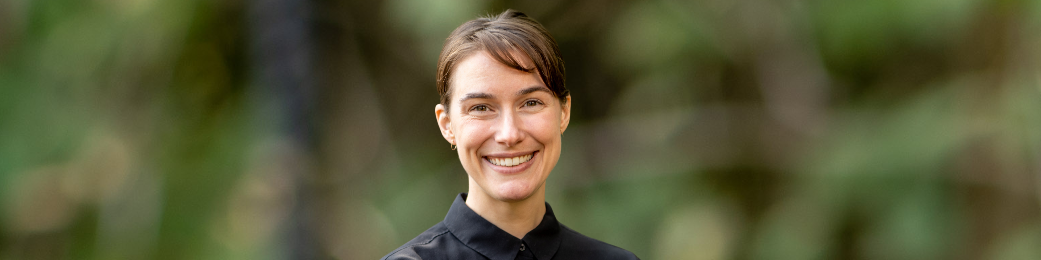 Headshot photo of EJSC Fellow Julia Brown against green background.