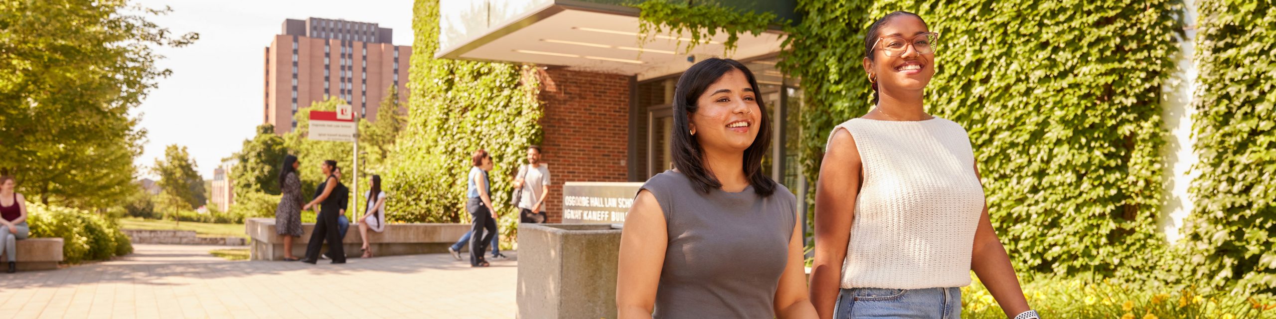 Two female law students walking in front of the law school